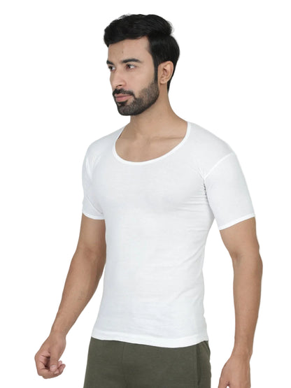 Man wearing a plain white t-shirt against a light gray background