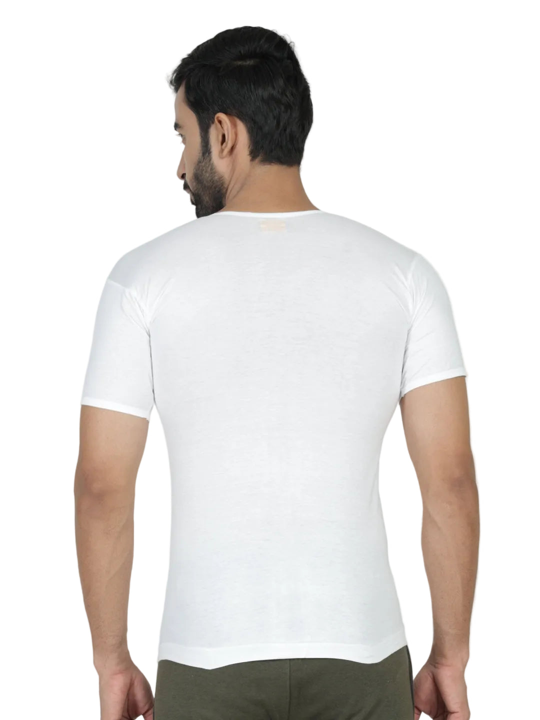 Man wearing a plain white t-shirt on a light gray background